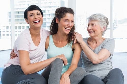 Cheerful fit women sitting in the yoga class