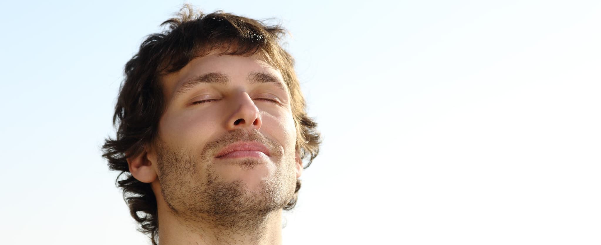 man breathing in happily