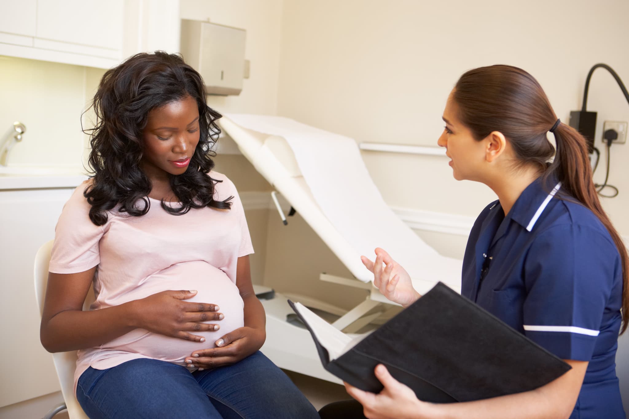 Pregnant Woman Being Given Ante Natal Check By Doctor