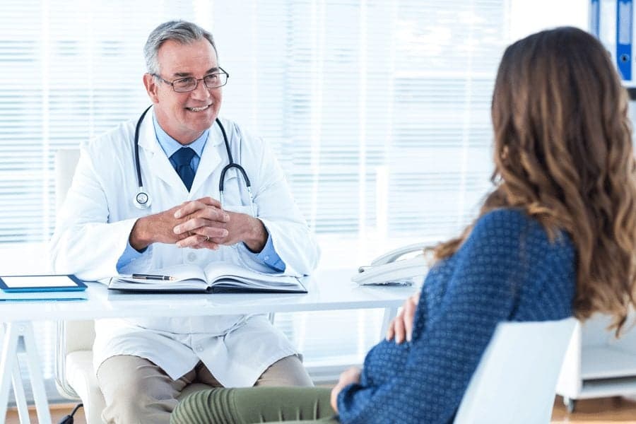 Picture of doctor talking to pregnant woman