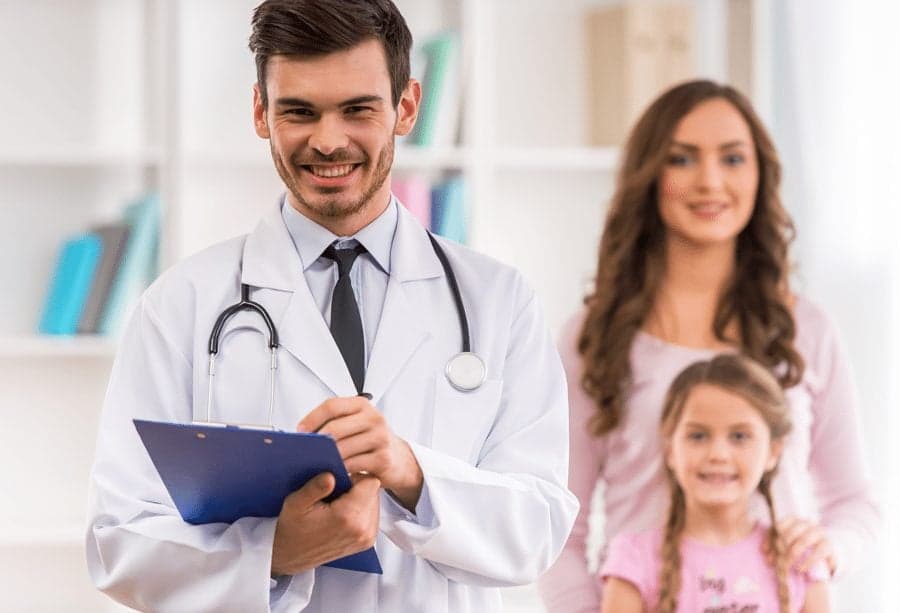 Picture of smiling doctor with patient - Family Medicine - Annual Physical Exams