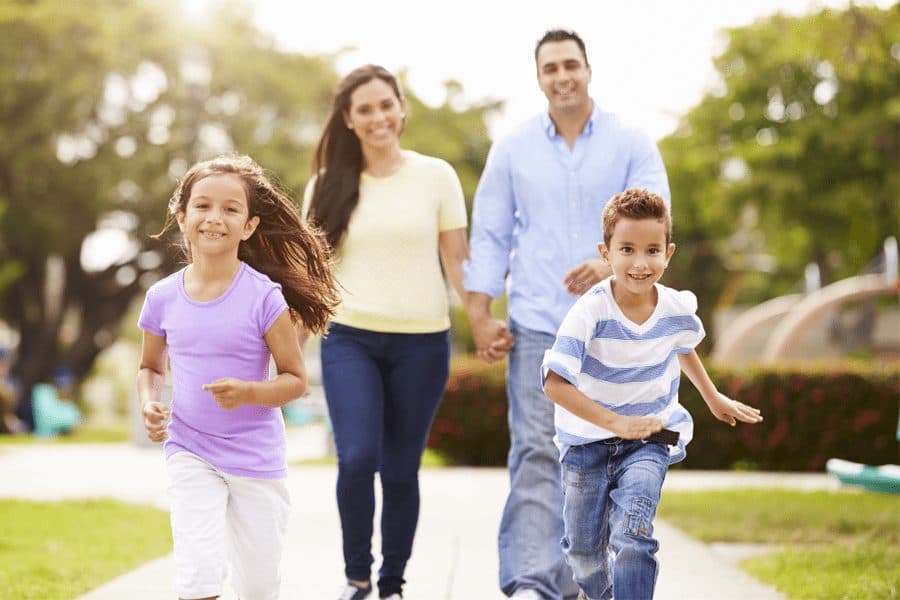 happy family running through park