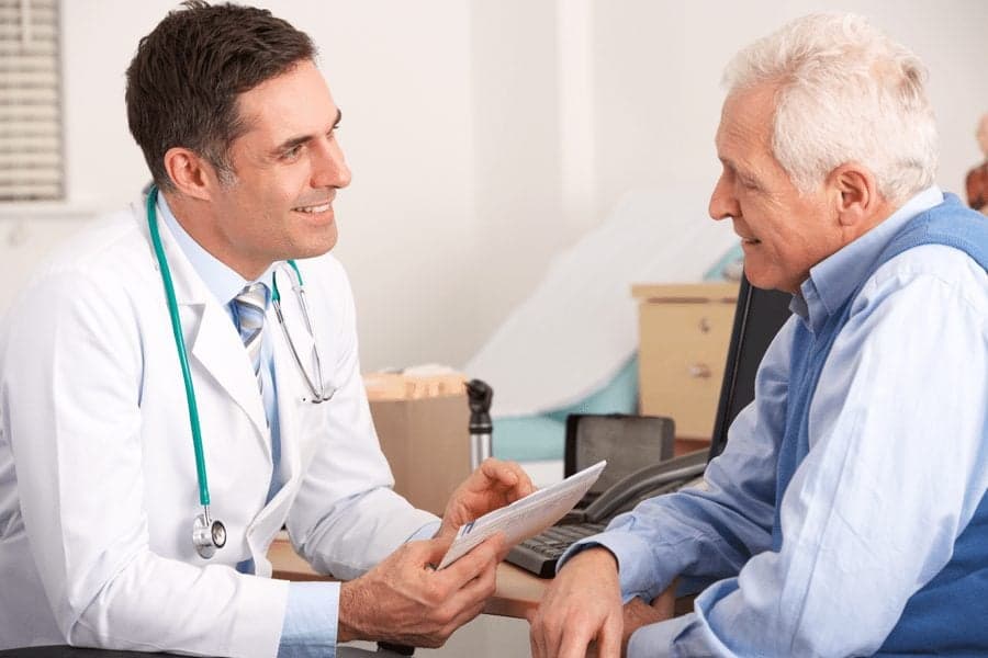 doctor explaining things to elderly man