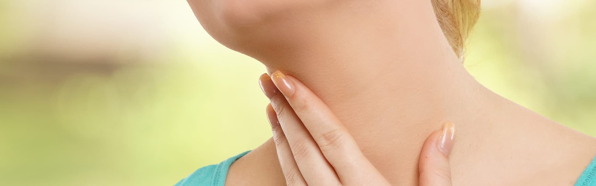 Picture of woman touching throat - Throat Problems