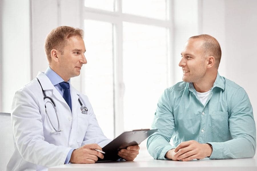 Picture of Doctor with clipboard talking to patient