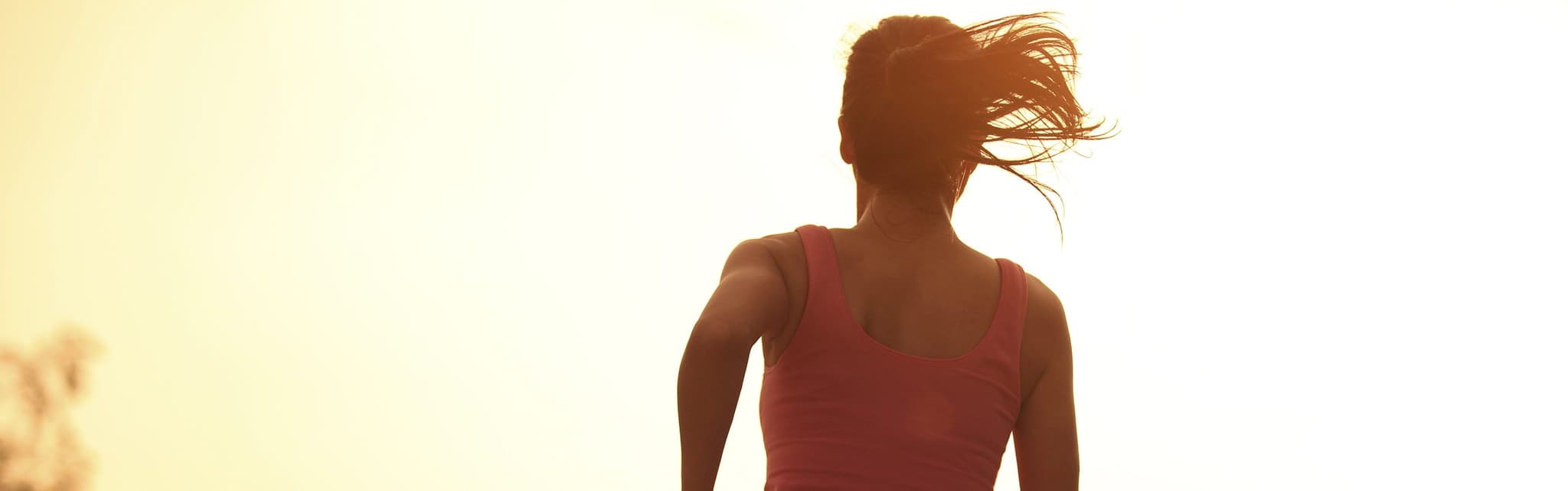 Picture of fit woman running at sunset