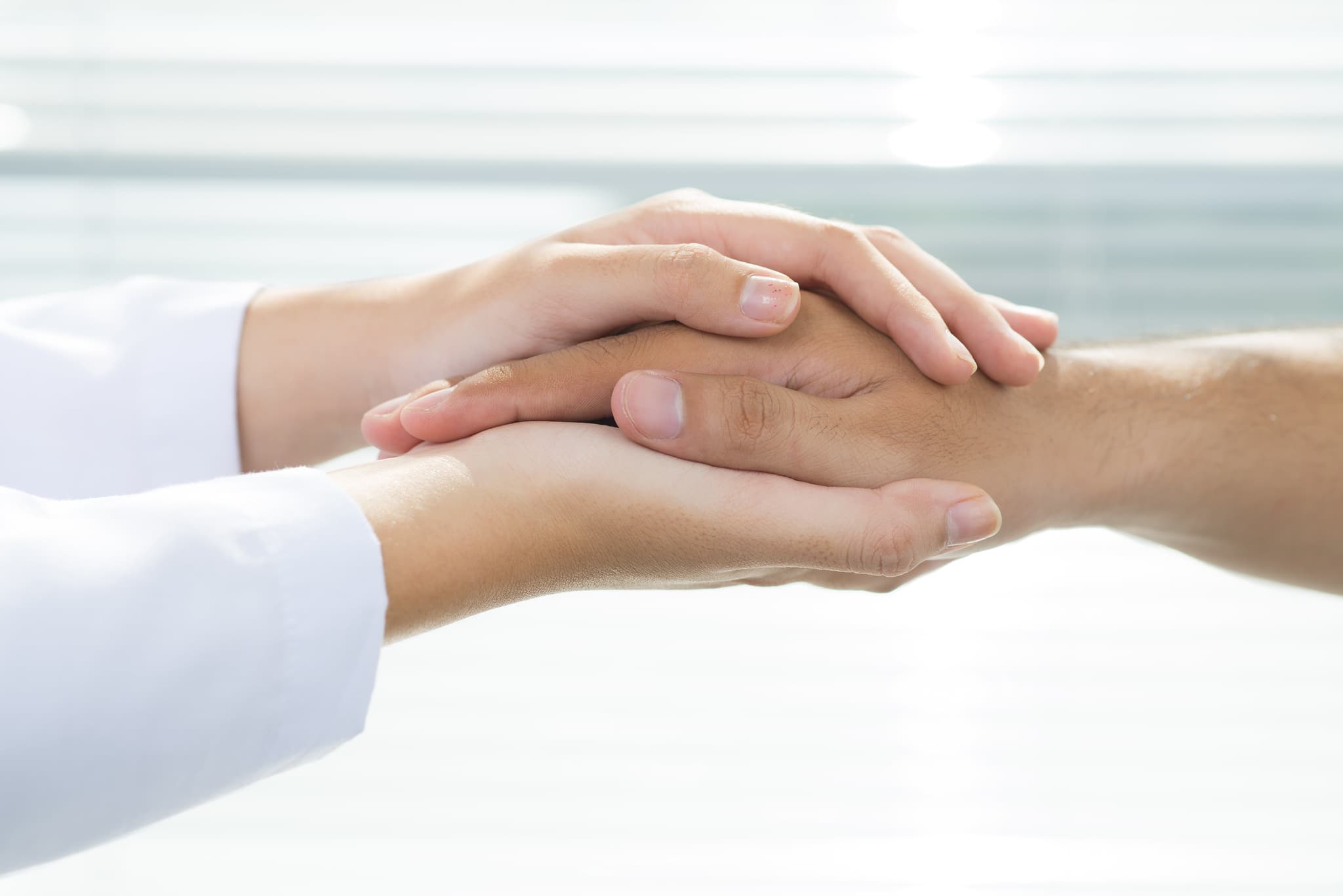 Picture of doctor holding patients hand