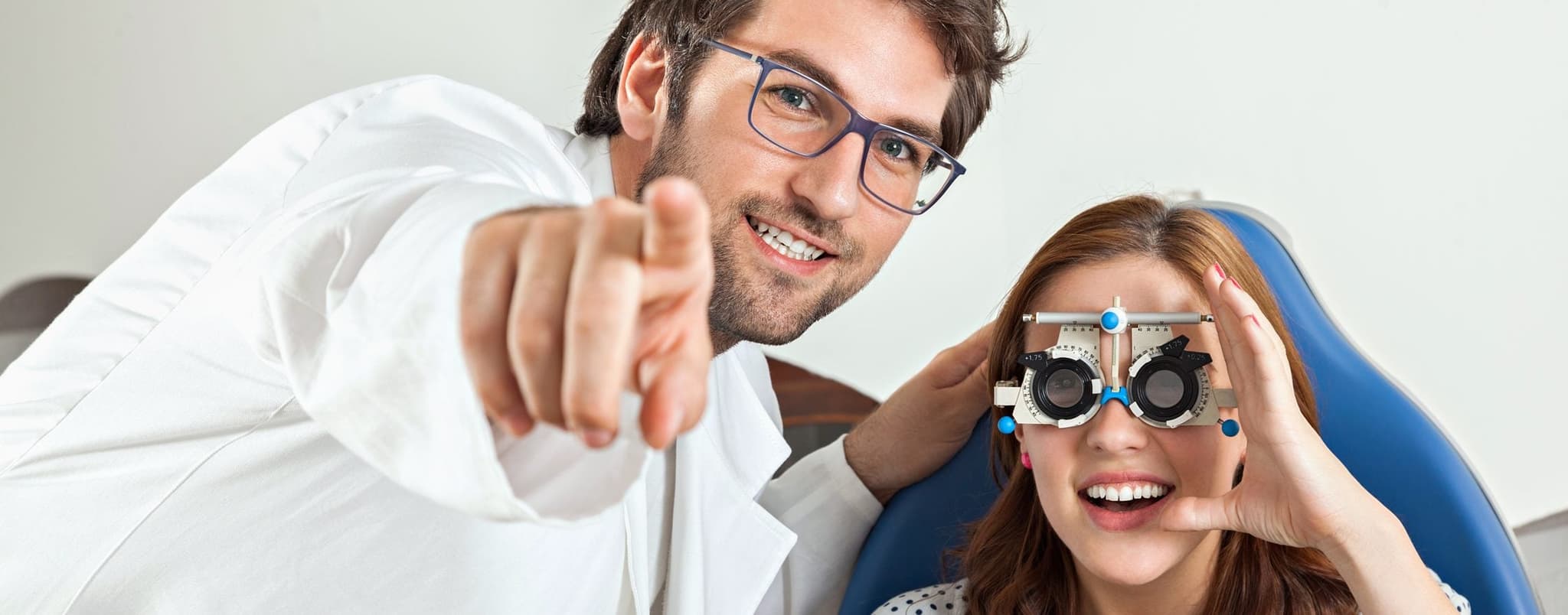 Ophthalmologist helping patient - woman getting vision tested