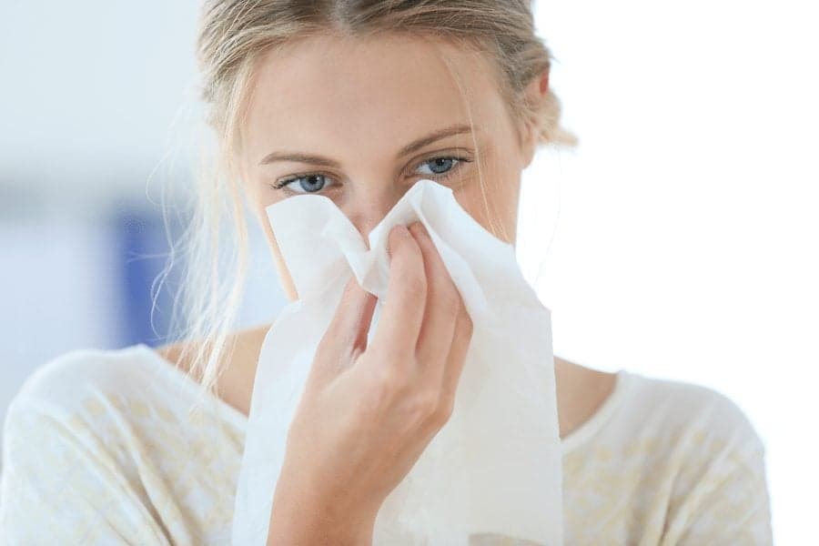 woman blowing nose