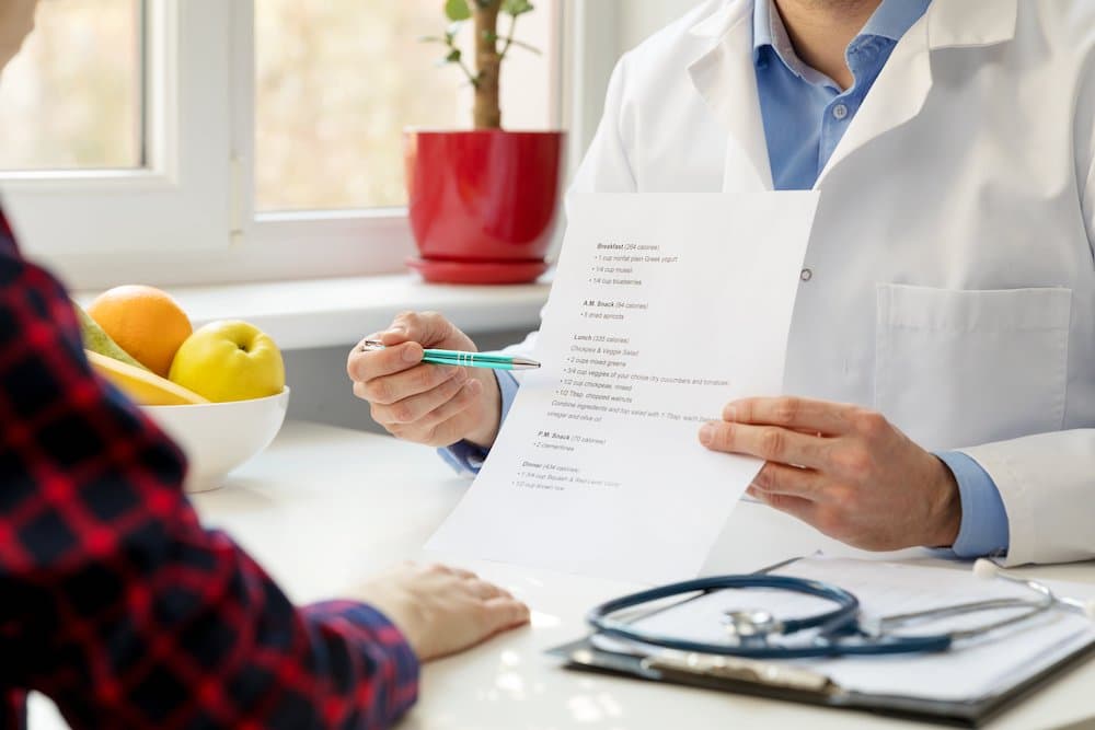nutritionist and patient discussing balanced nutrition plan in office