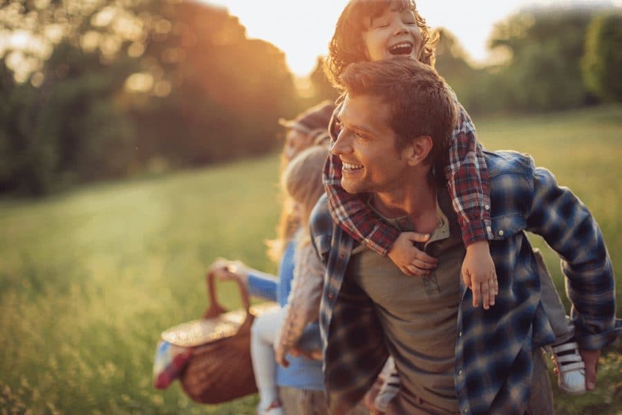 happy family playing in park - family planning picnic