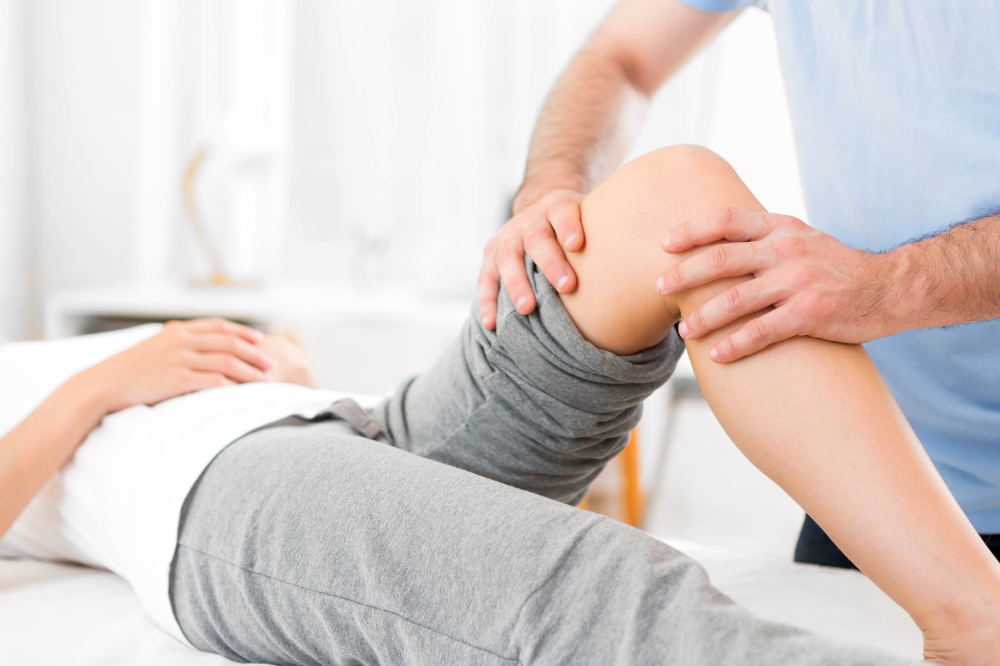 Young attractive woman being helped by physiotherapist