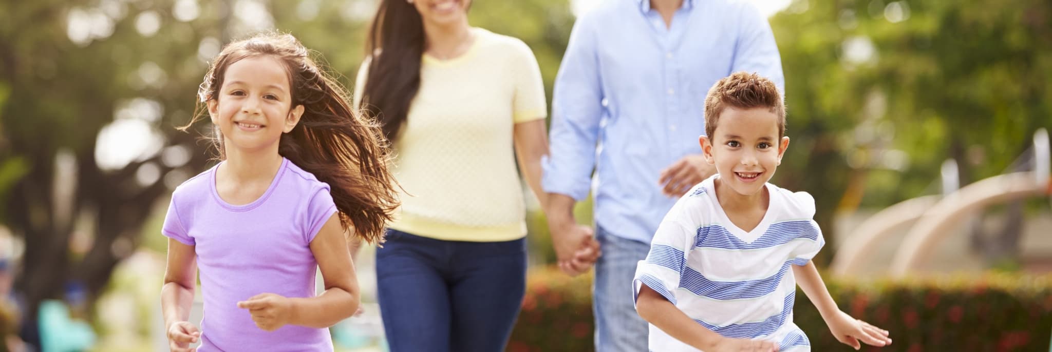 Picture of happy family running through park