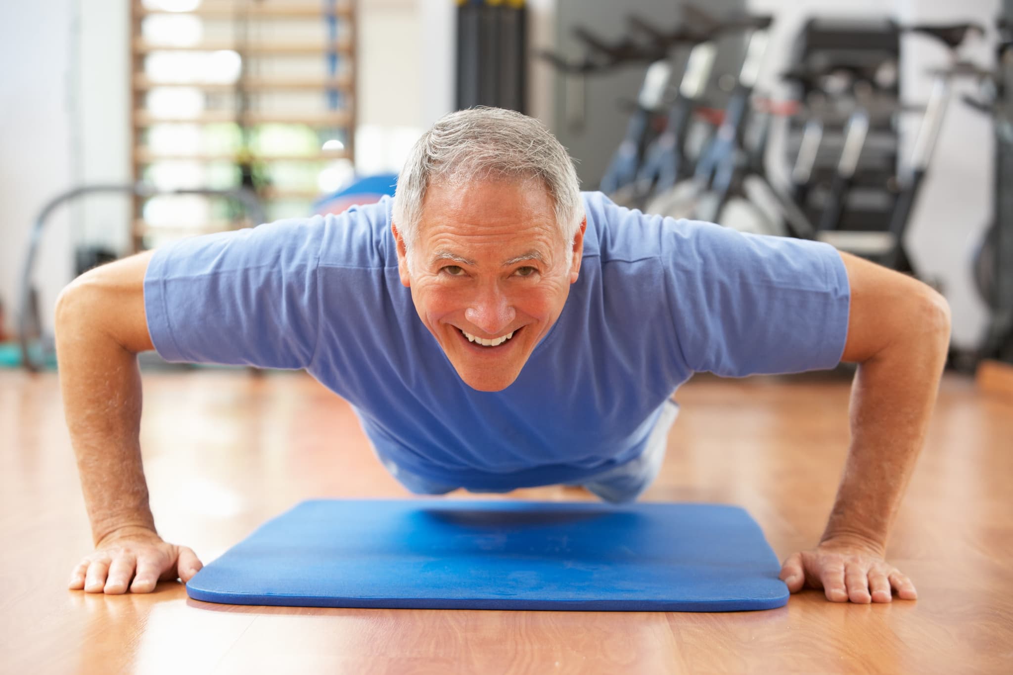 Picture of Senior Man Doing Press Ups In Gym