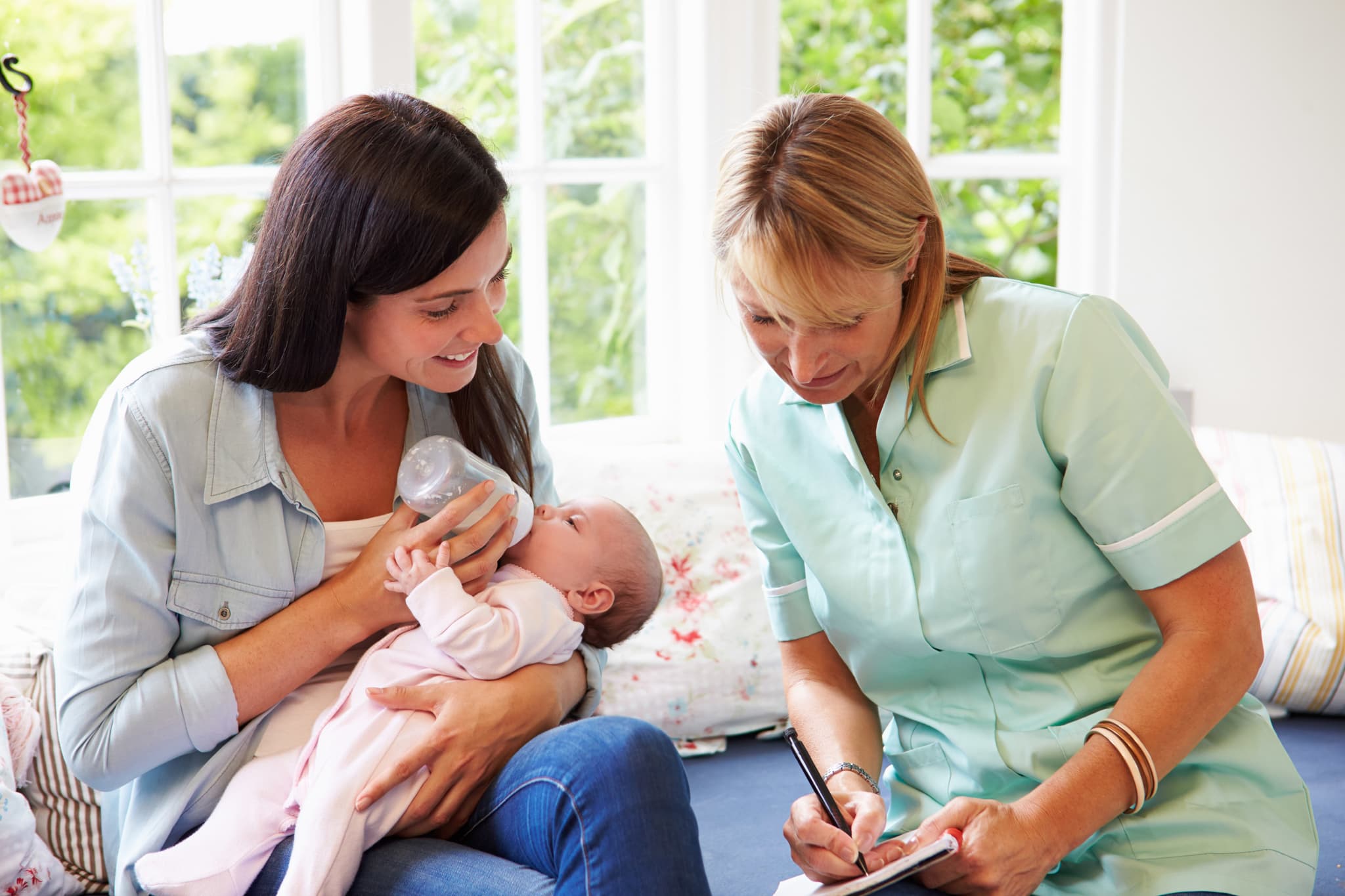 Picture of Mother With Baby Meeting With Health Visitor At Home