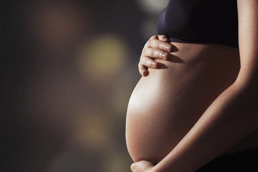 pregnant woman touching belly