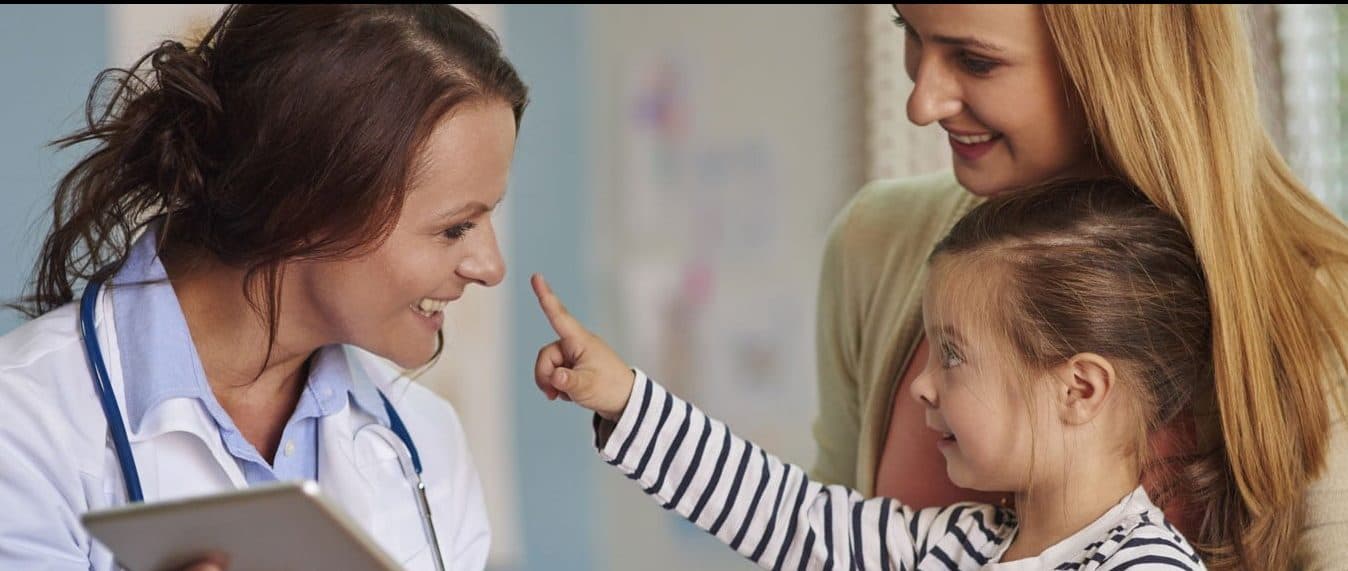 Picture of mother and daughter talking with smiling doctor