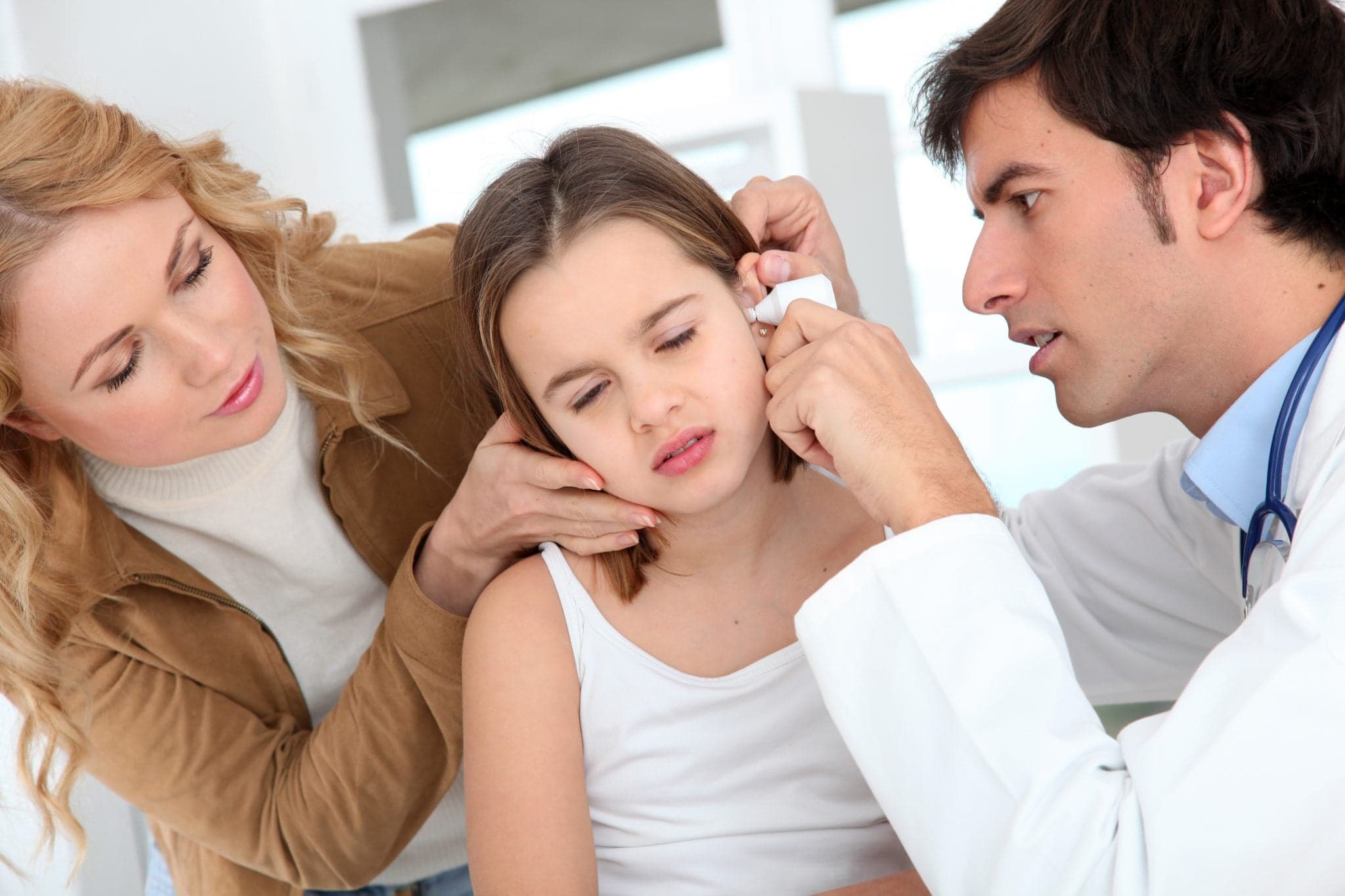 Picture of Doctor looking at little girl ear infection