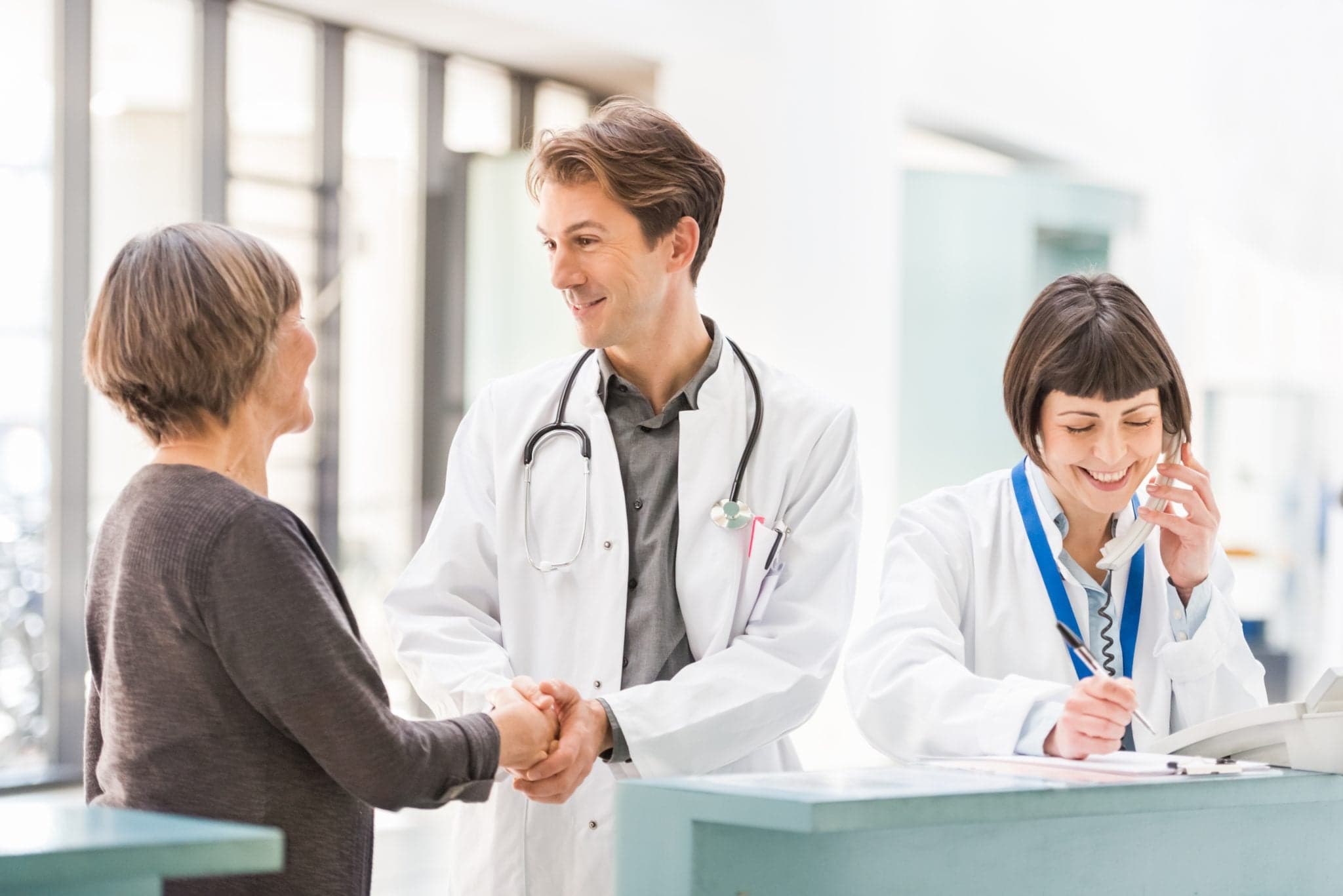 Picture of Doctors and Patient at Reception Desk