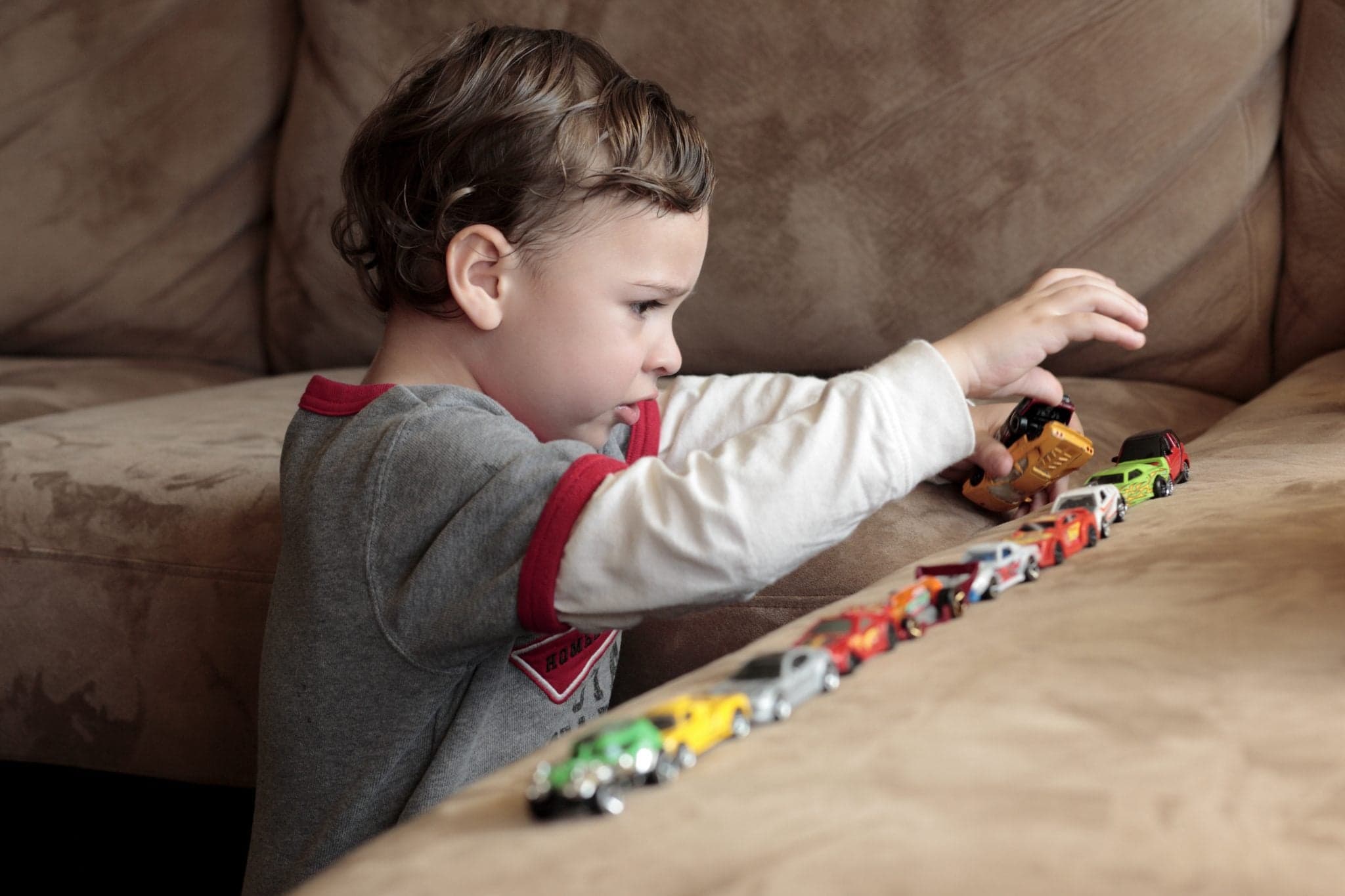 Picture of Autistic boy lining up toy cars