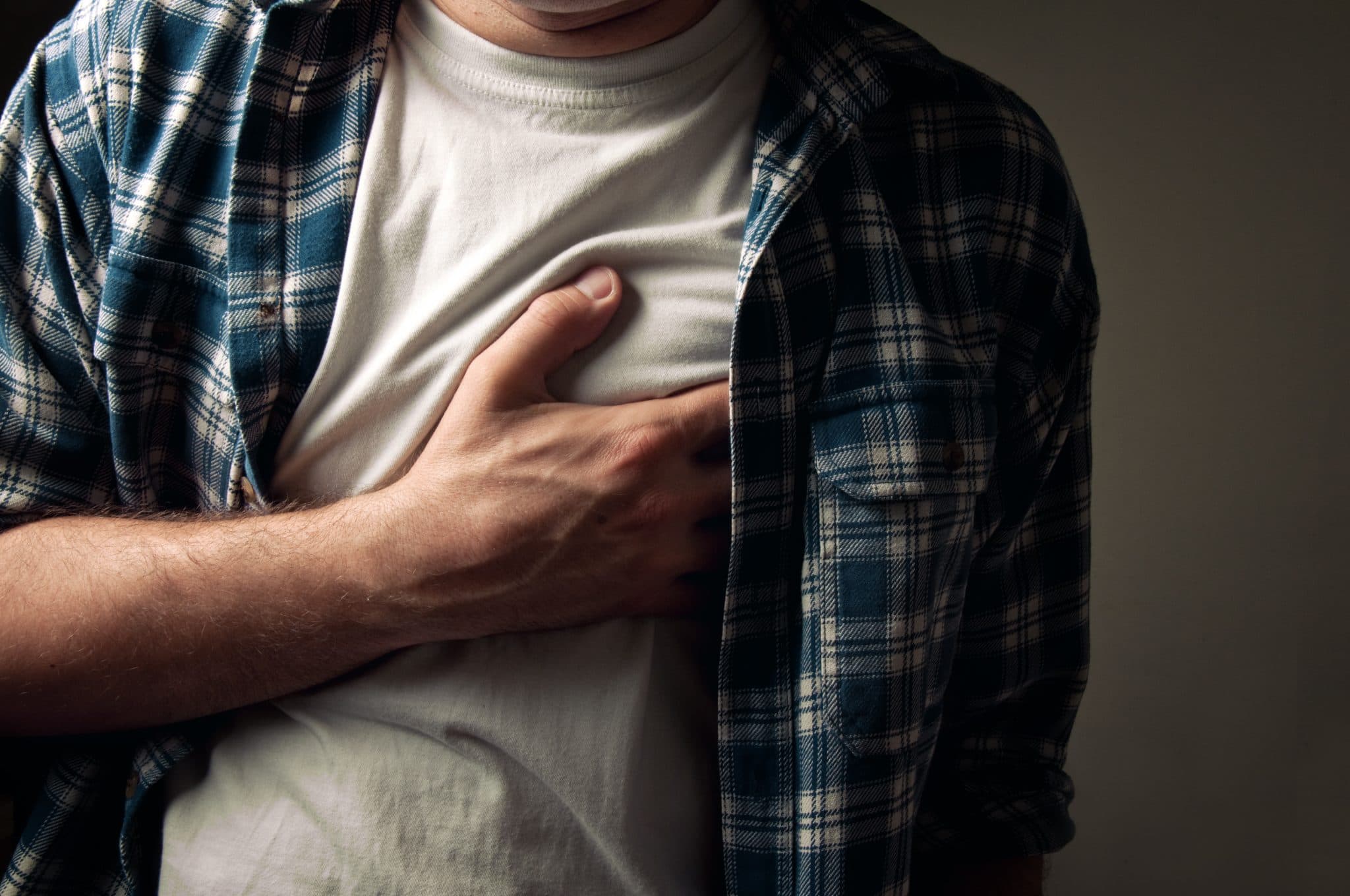 Picture of Young adult man suffering from severe heartache, low light condition