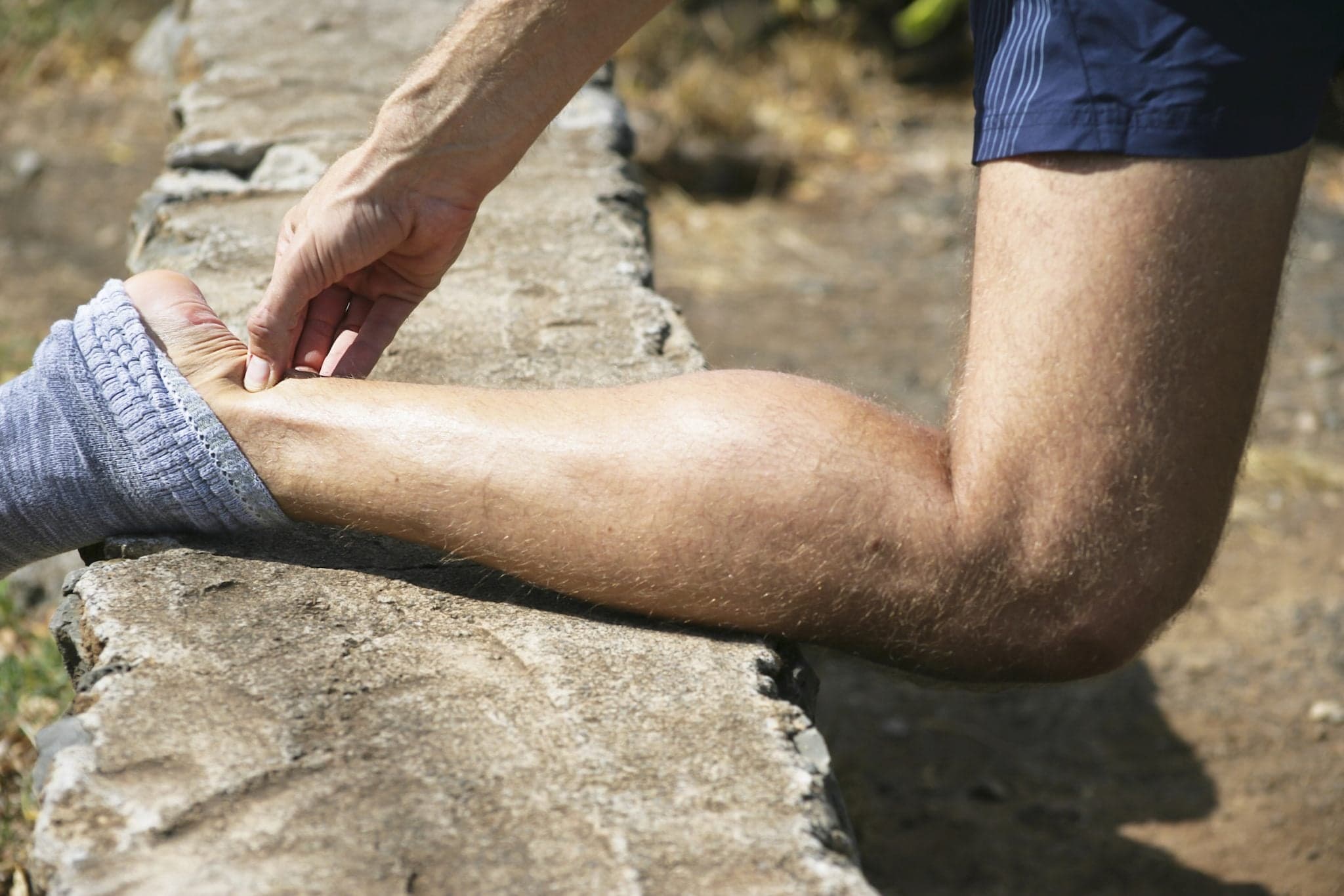 Picture of Typical pain in a male jogger`s Achilles tendon.