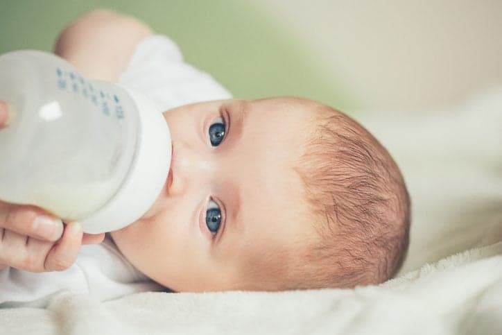 Close-up of a baby boy drinking milk froma bottle