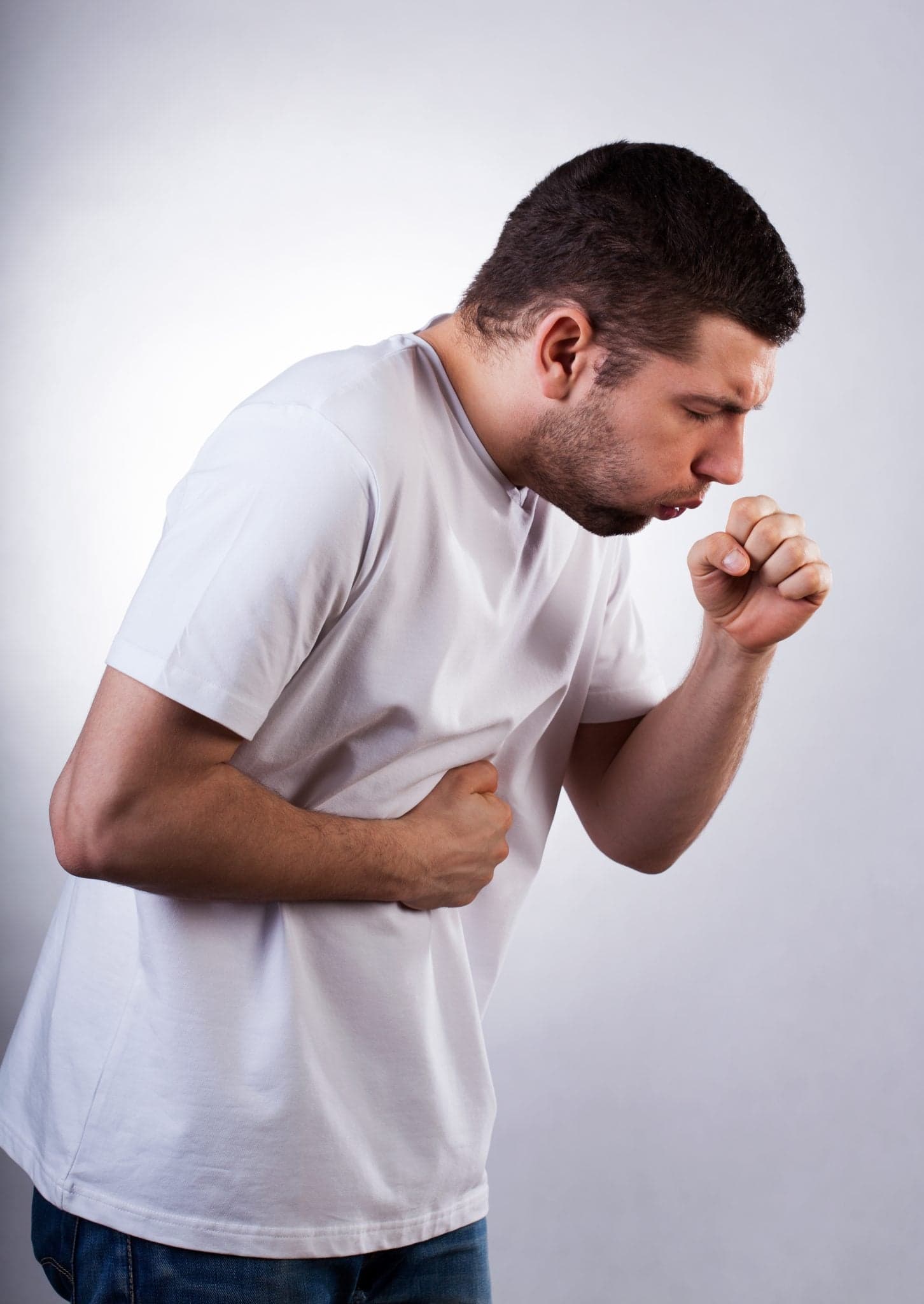 Strongly coughing young man suffered from asthma