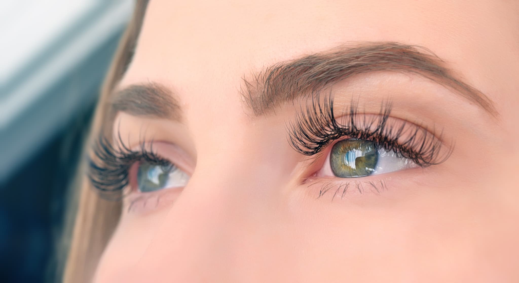 Picture of side view of woman green eyes looking away, long eyelashes. horizontal shot.