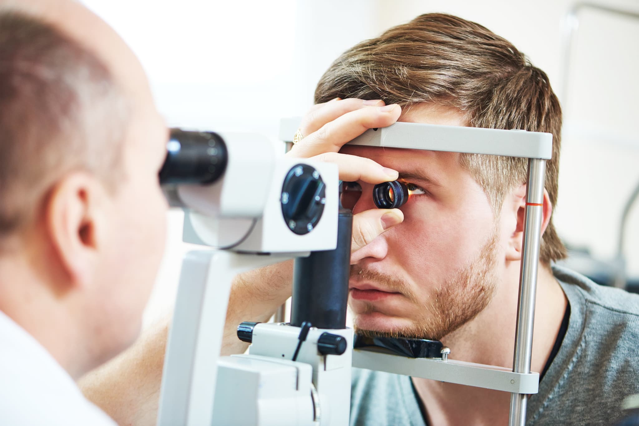 Picture of Ophthalmology concept. Male patient under eye vision examination in eyesight ophthalmological correction clinic