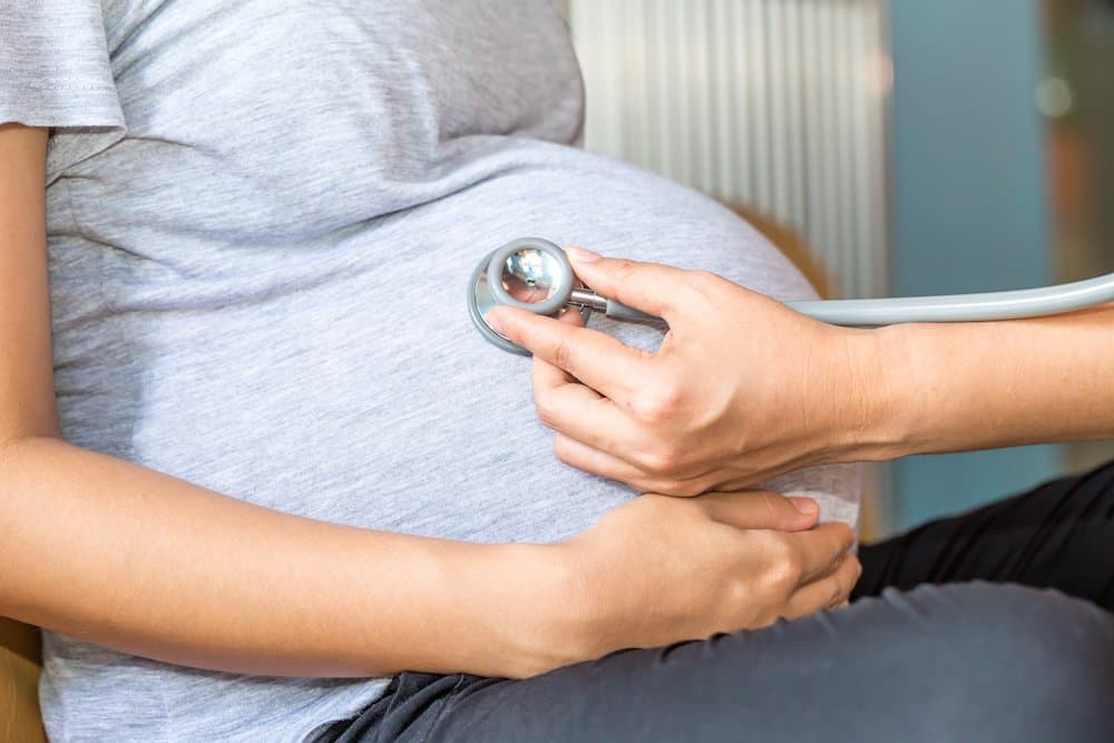 Picture of Hands of doctor examining a pregnant woman