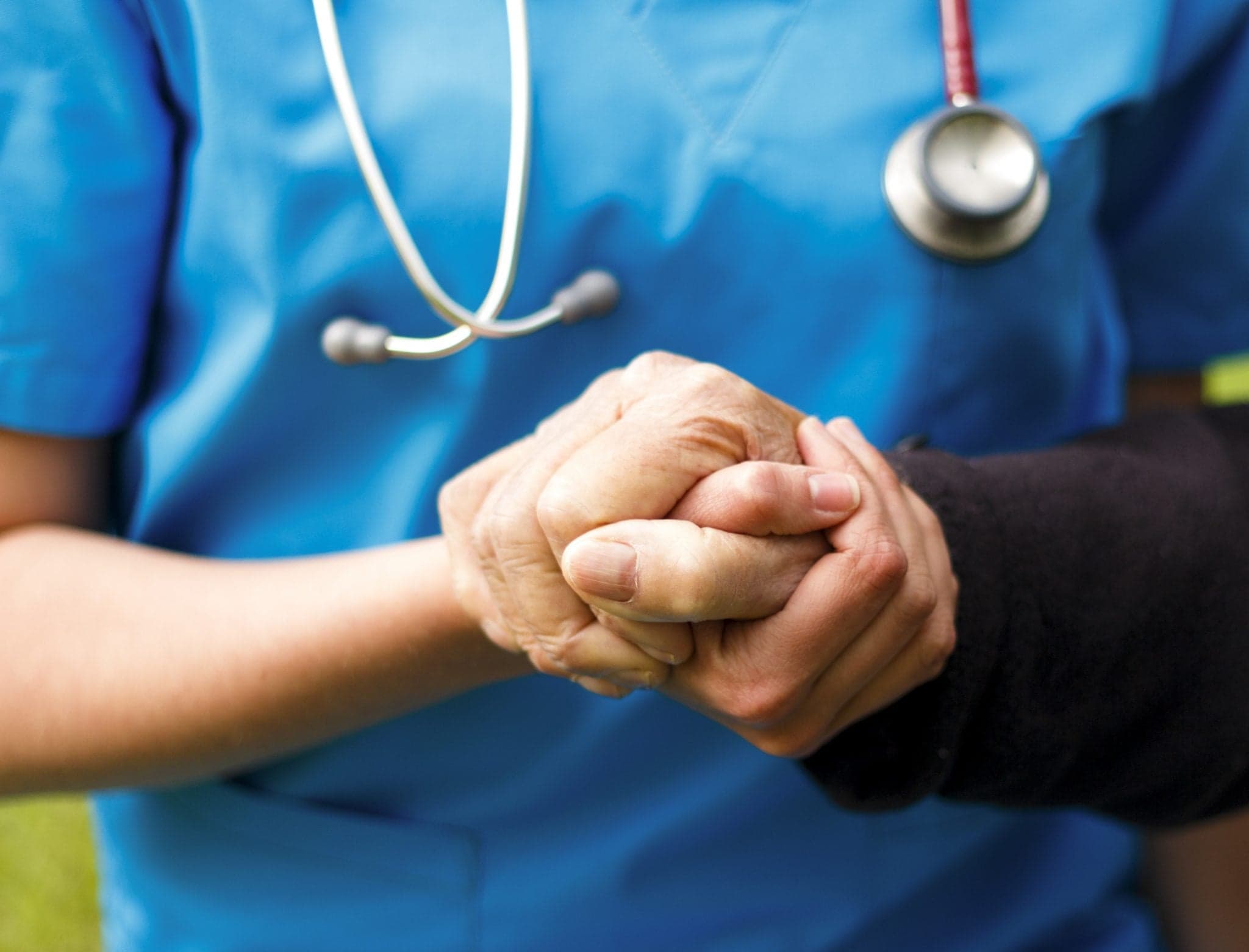 Doctor helping old patient with Alzheimer's disease.