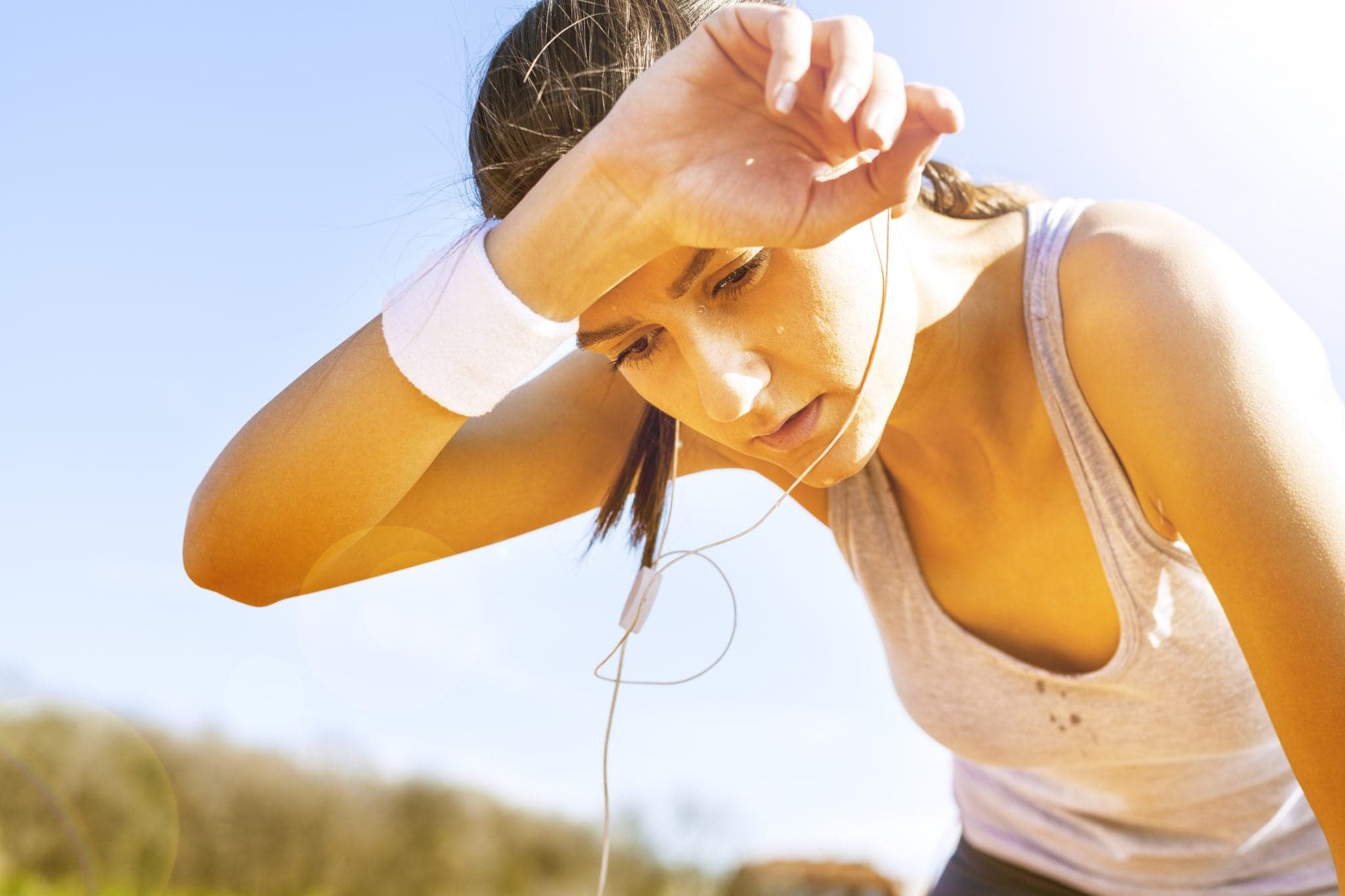 Young sportswoman resting after running.