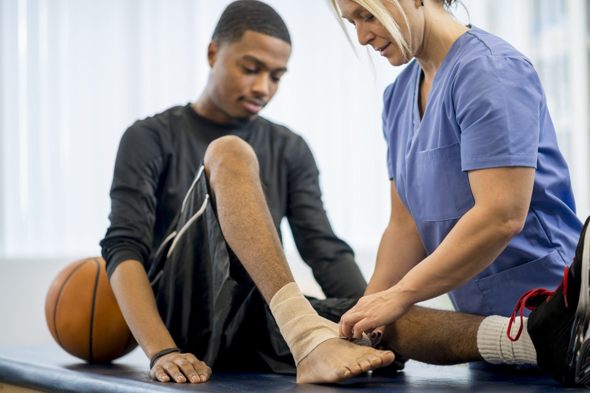 Image of Baksetball Player Getting Bandaged Up