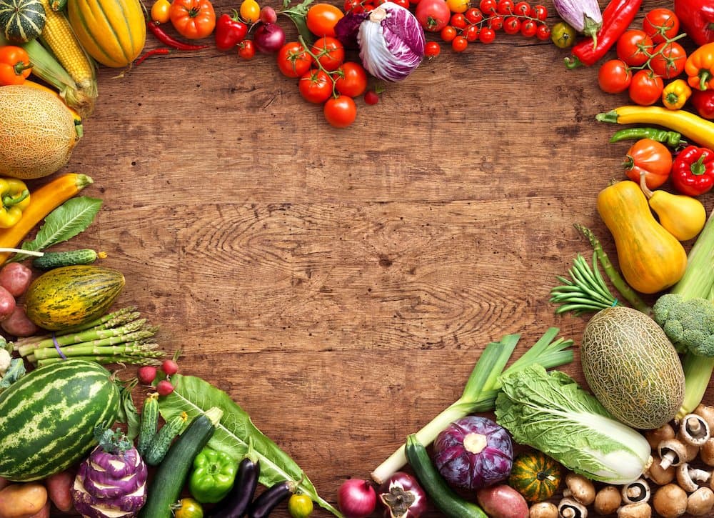 Picture of Heart shaped food. Food photography of heart made from different fruits and vegetables on rustic wooden table. High resolution product