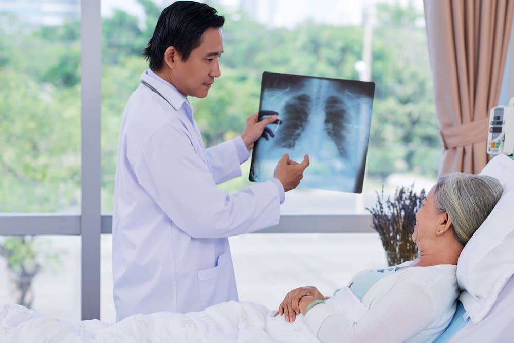 doctor Showing x-ray to elderly patient