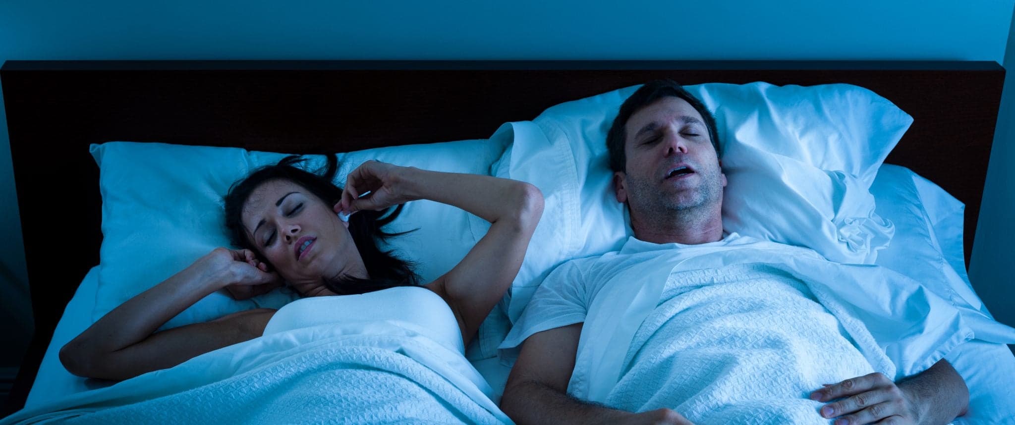 Picture of woman can't sleep because man is snoring