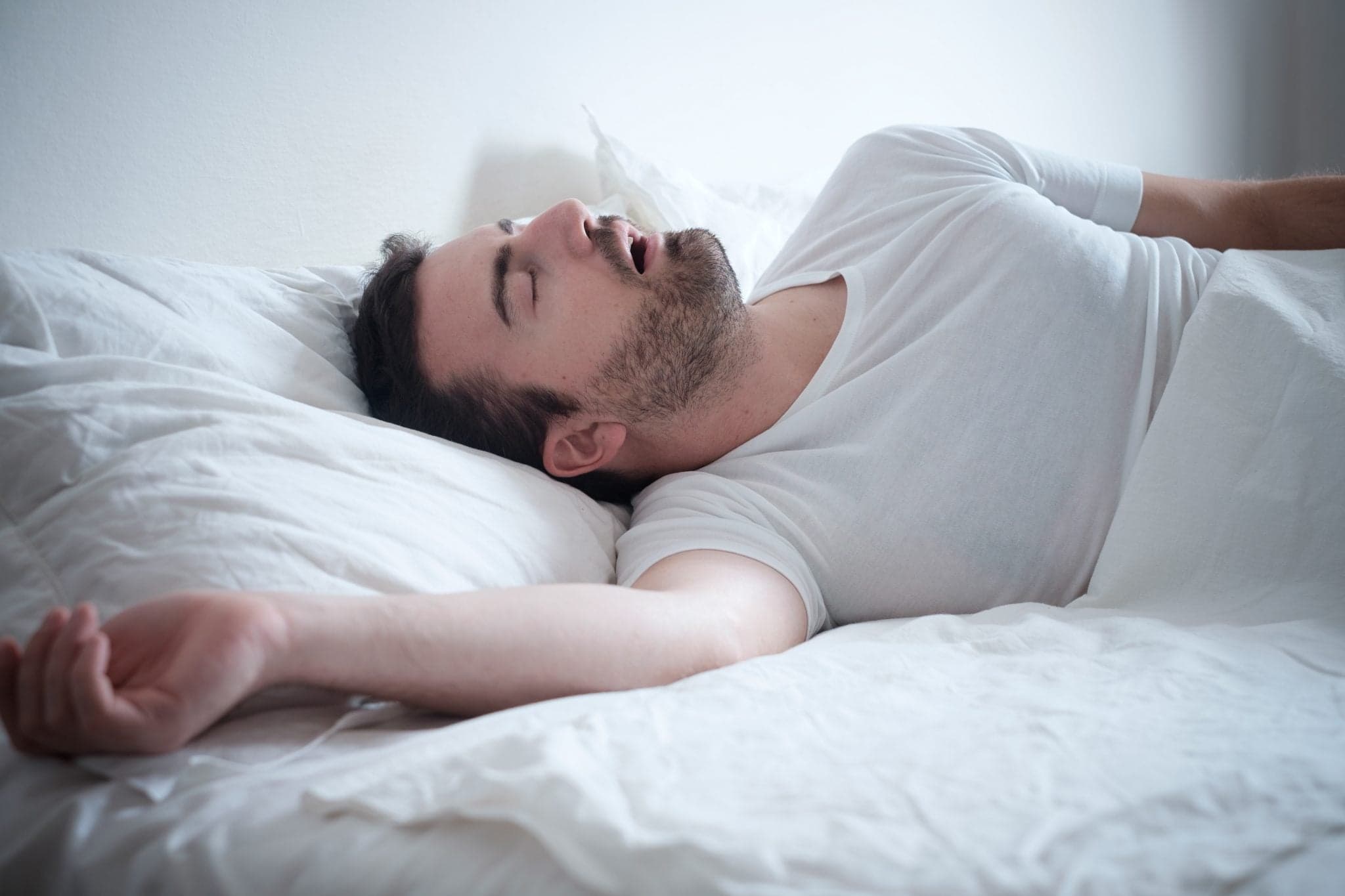 Picture of Man sleeping in his bed and snoring loudly