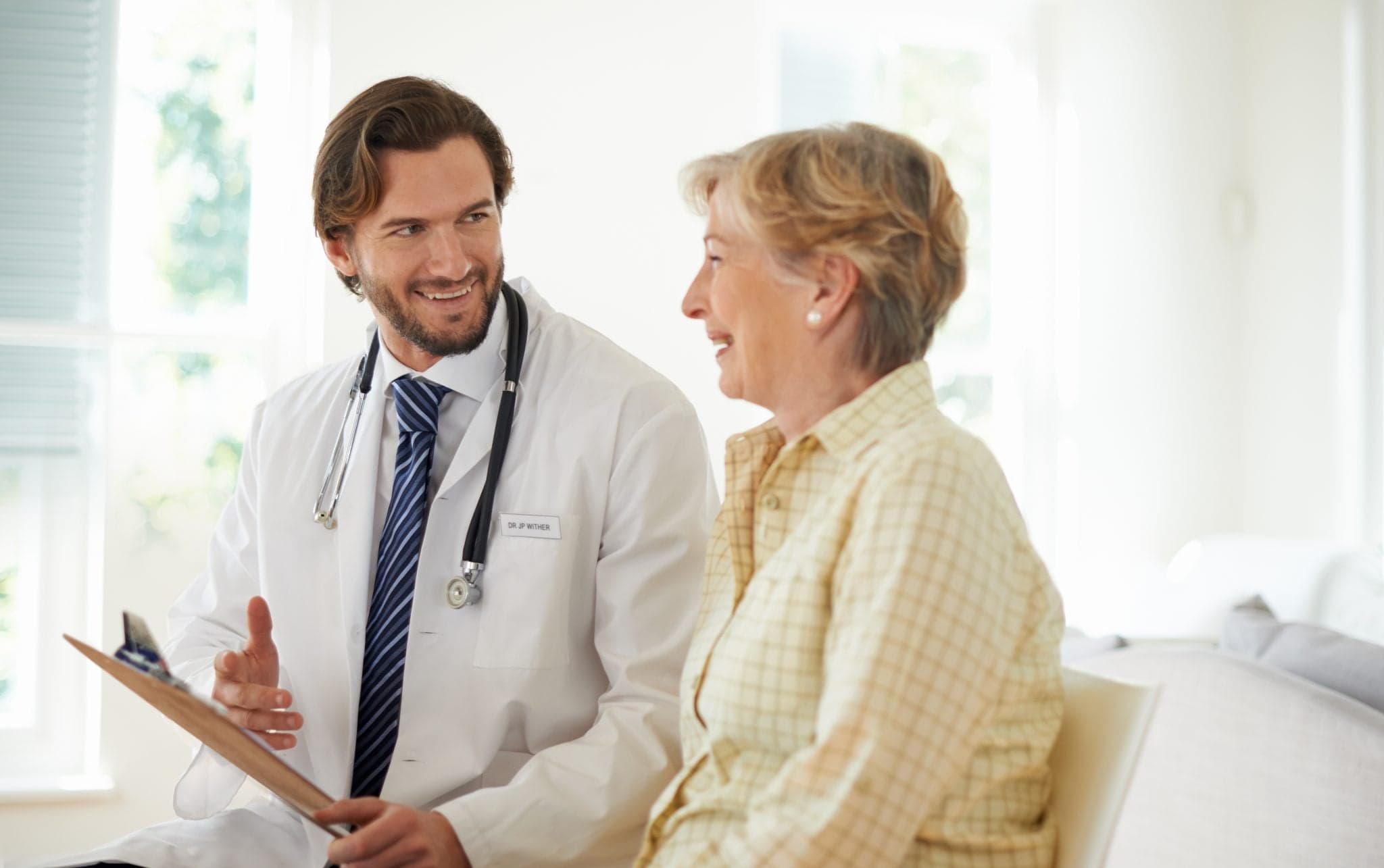 doctor talking to older patient