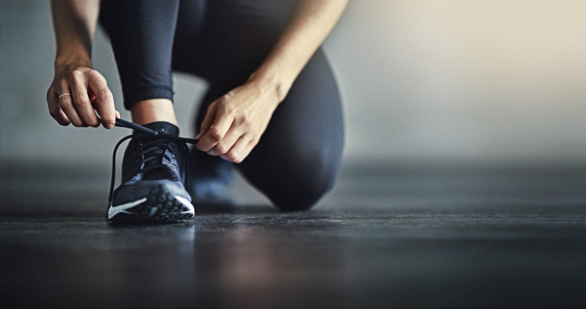 Picture of Cropped shot of a woman tying her shoelaces before a workout