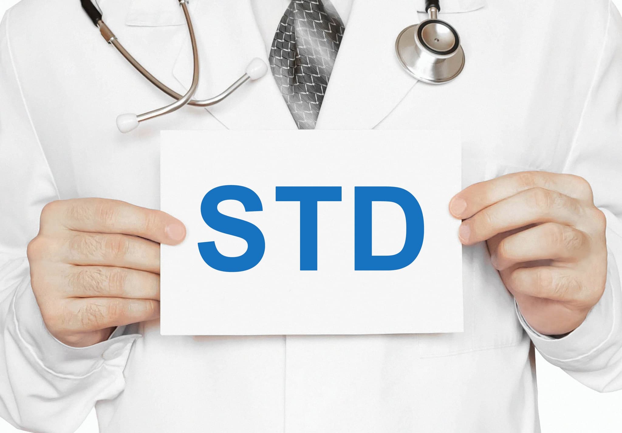 Picture of Doctor holding a card with STD, medical concept