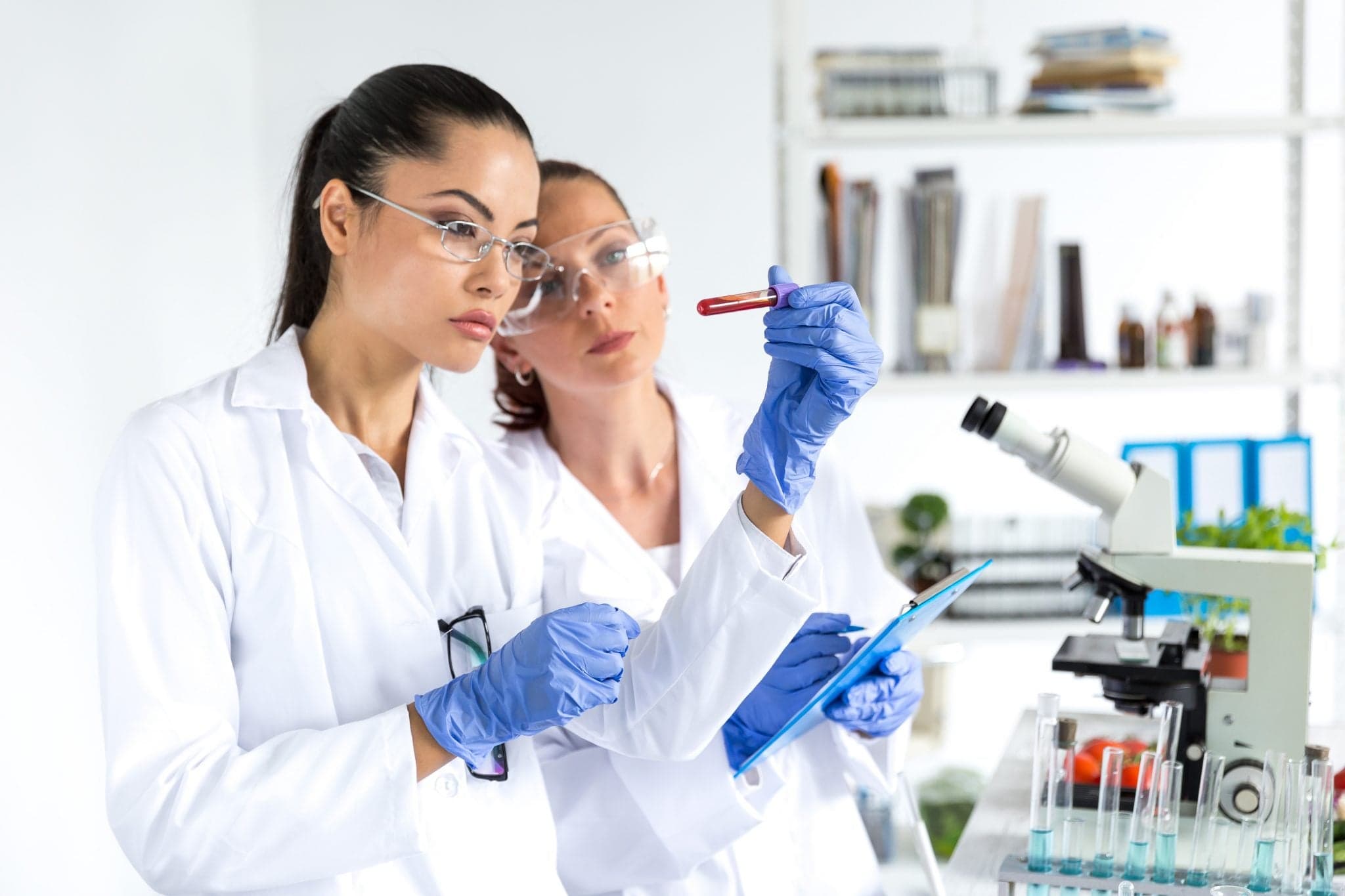 Picture of Two female laboratory technicians making blood tests.