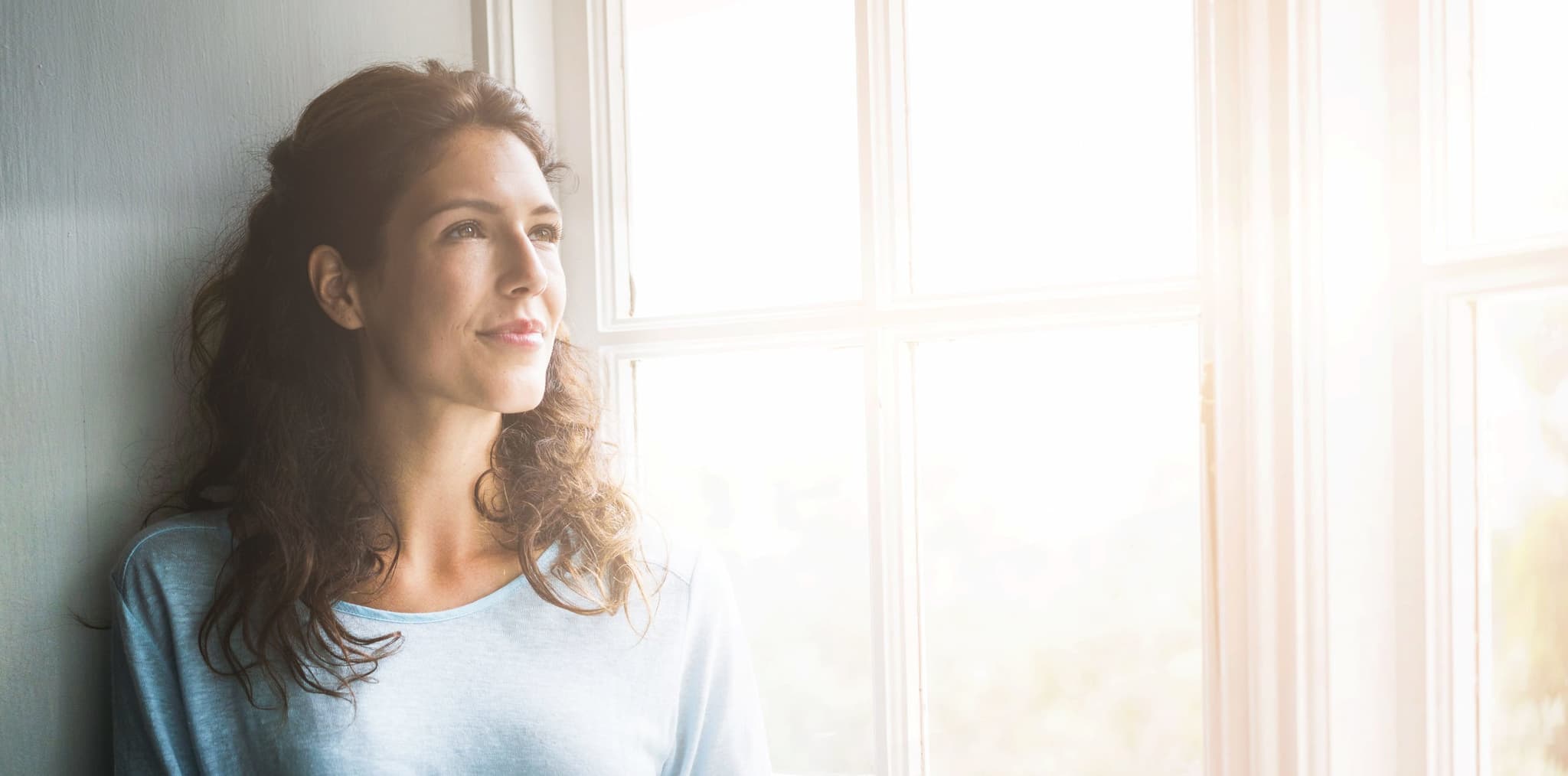 Picture of Thoughtful young woman looking out window