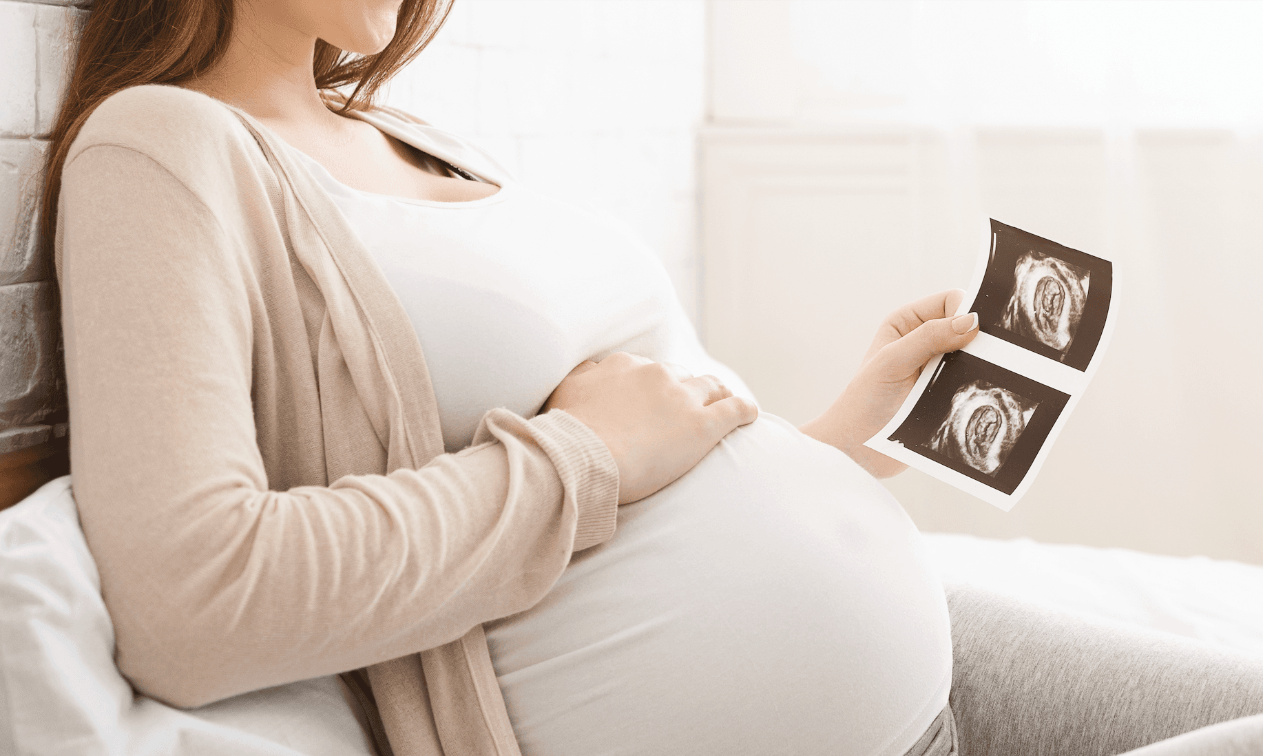 Image of woman holding sonogram