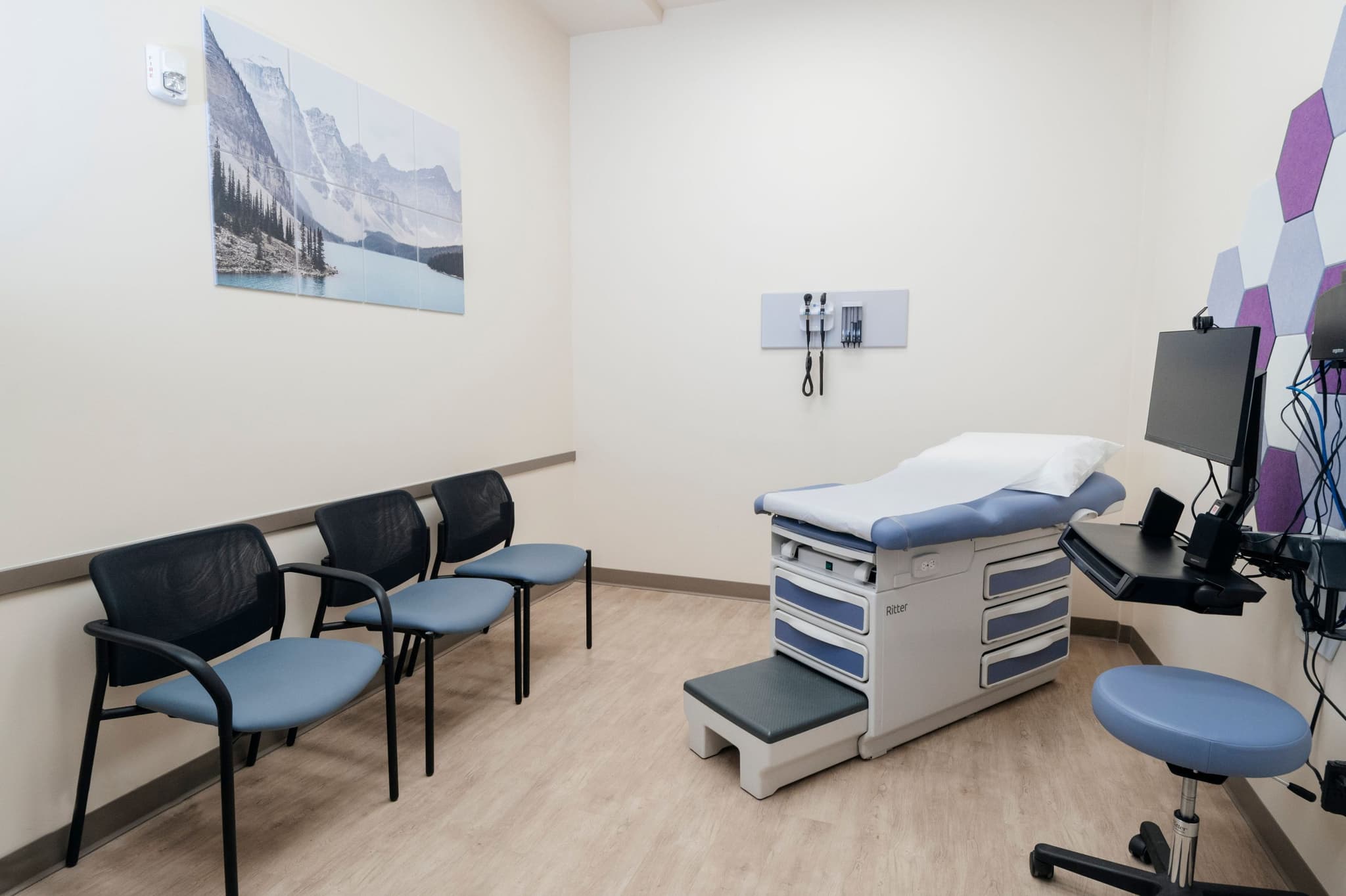 Image of Medical exam room with an exam table and guest chairs, designed for one-on-one assessments and follow-up care.