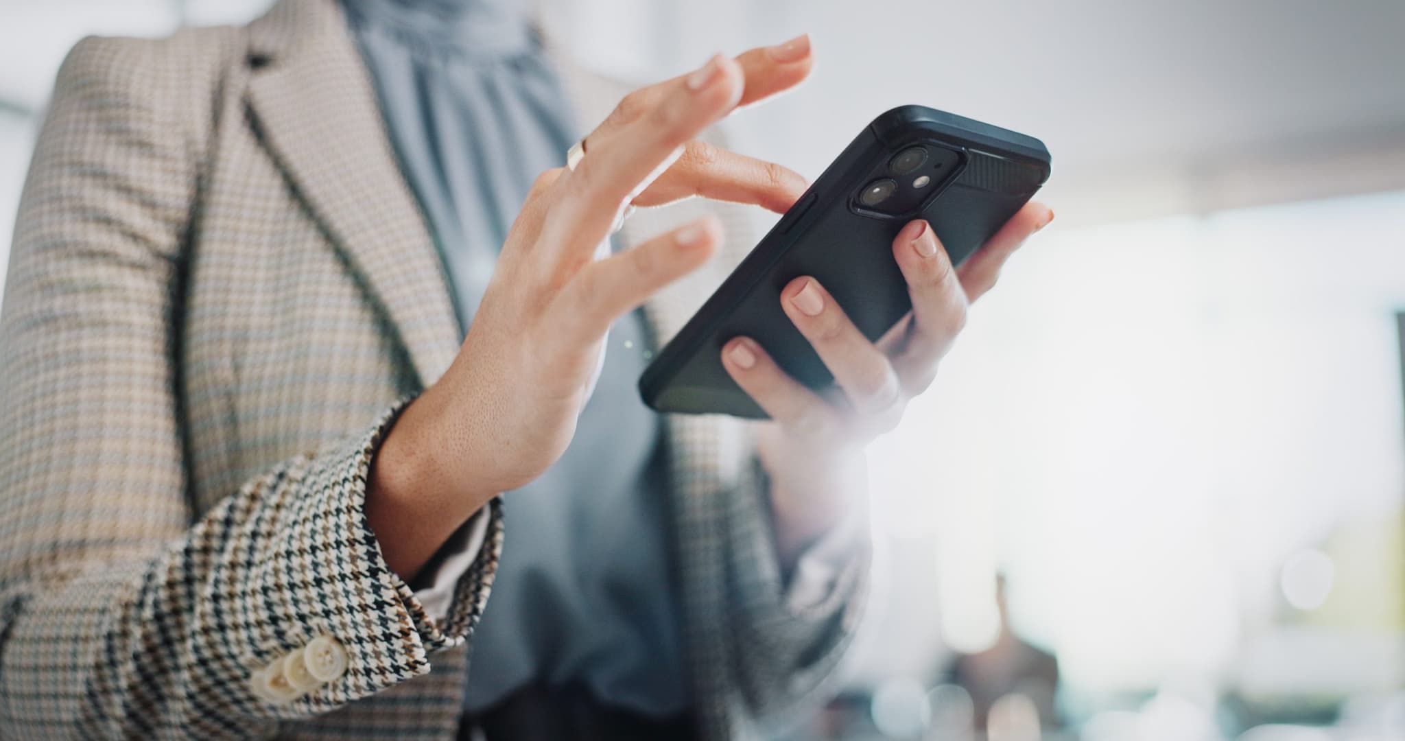 Picture of Business woman, hands and typing with phone for research, online browsing or reading news at office. Closeup of female person or employee scrolling on mobile smartphone for chatting, texting or app.
