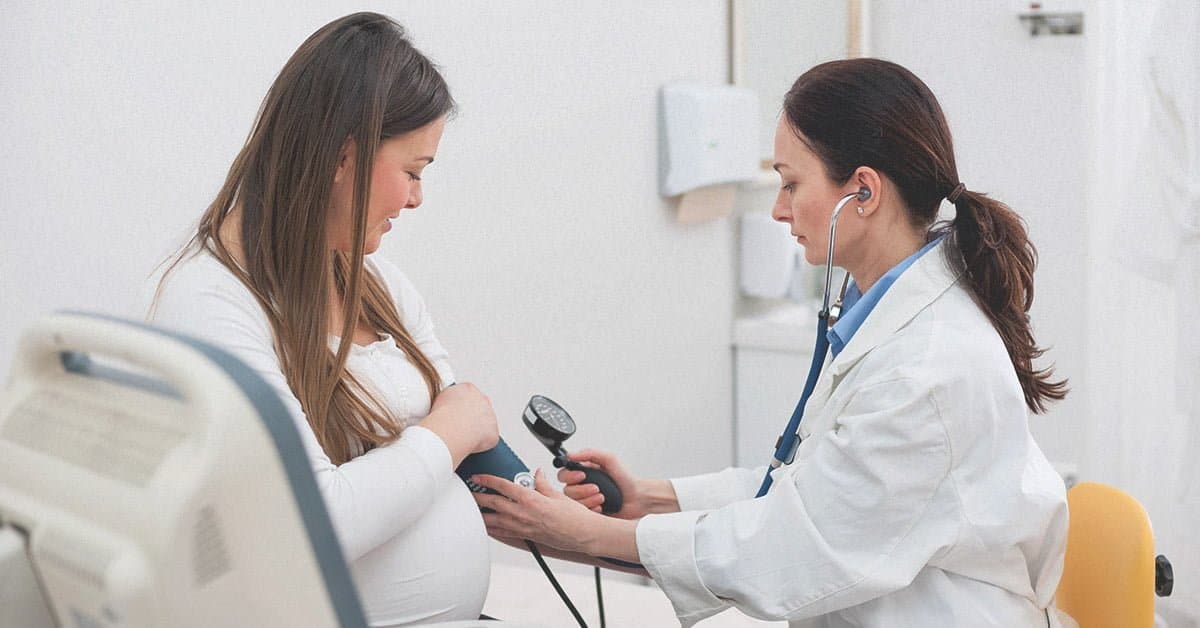 Image of doctor taking blood pressure of Pregnant woman