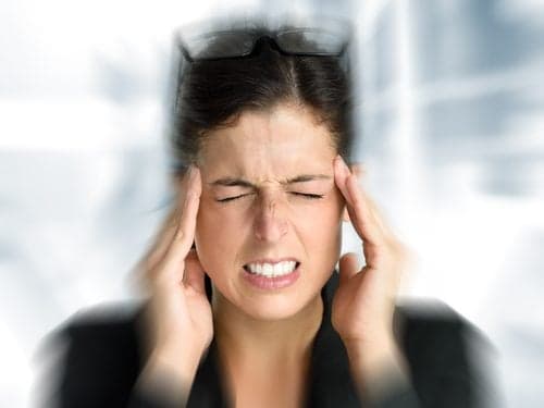 Picture of Businesswoman with intense stress and painful headache. Woman in job problems.