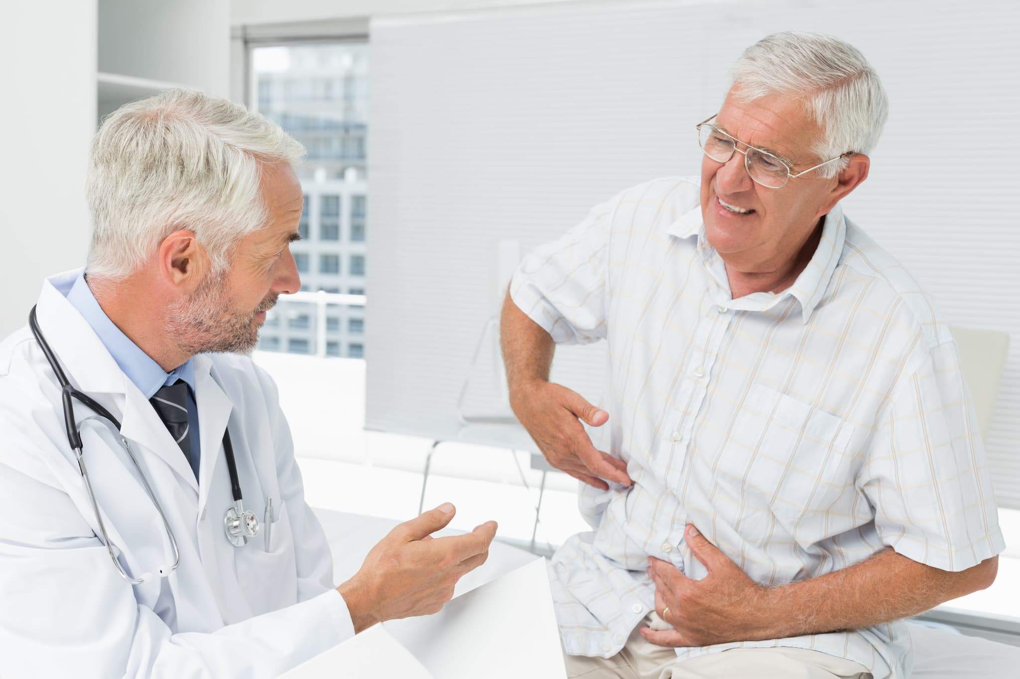 Picture of man with Acid Reflux and Heartburn talking with doctor