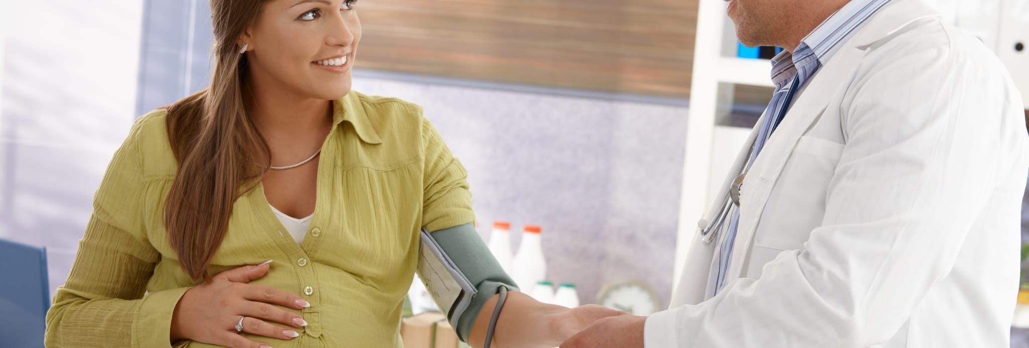 Picture of doctor taking blood pressure of pregnant woman